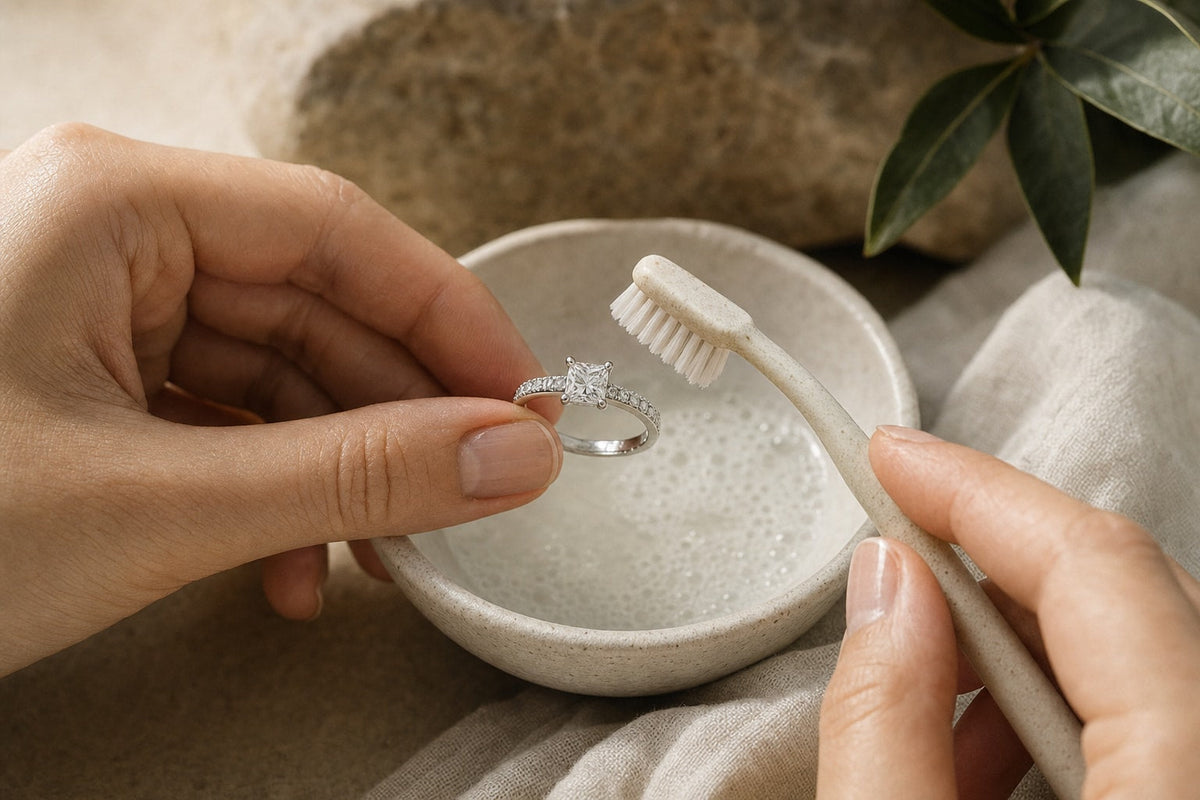 Cleaning a diamond engagement ring with a soft brush and warm soapy water